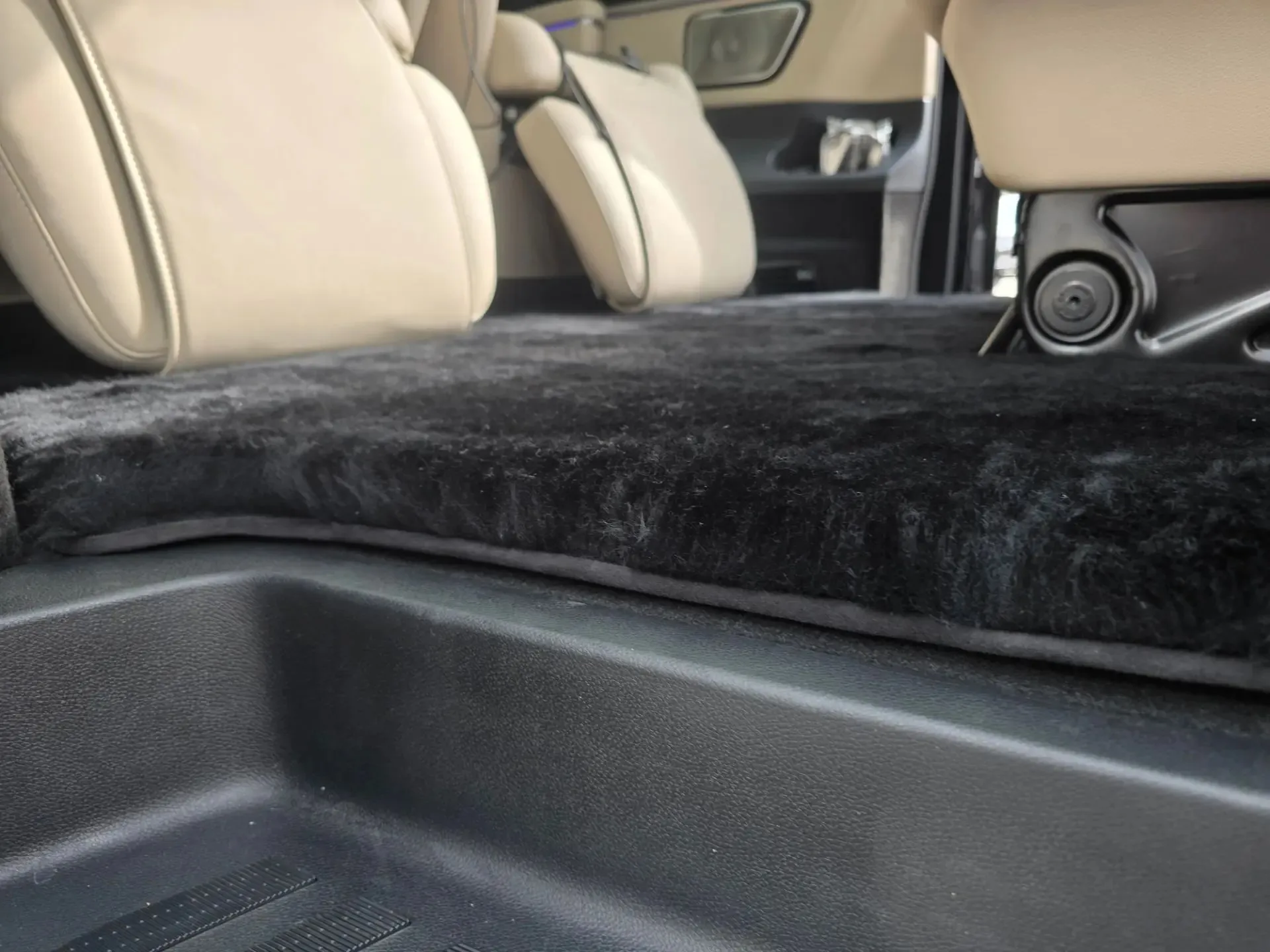 Готовый меховой ковёр из овчины установлен на полу второго ряда Mercedes-Benz V-класса, бежевый кожаный салон
