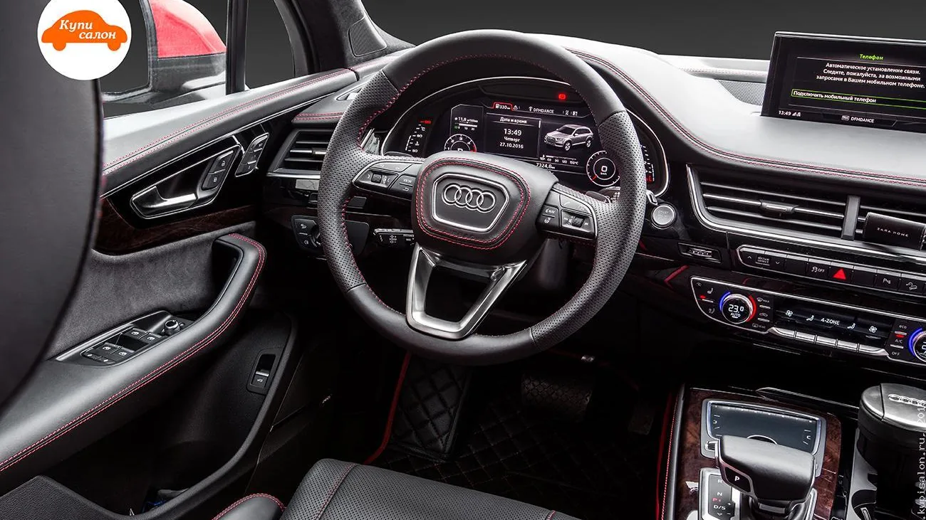 Перетяжка салона Audi Q7 черной перфорированной кожей с красной строчкой, руль, сиденья, дверные карты, центральная консоль, коврики.