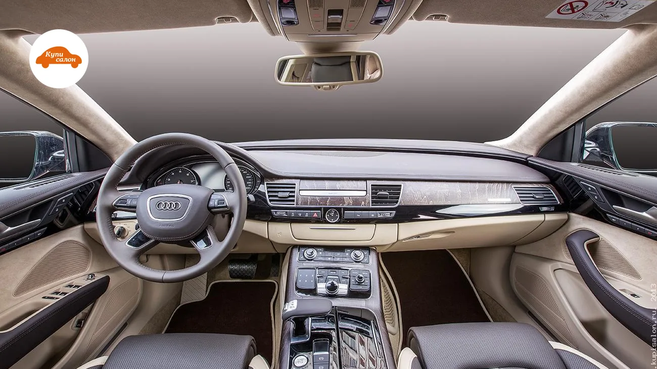 Перетяжка салона Audi A8: сиденья, руль, торпедо, двери, потолок в коричневой и бежевой коже с перфорацией.