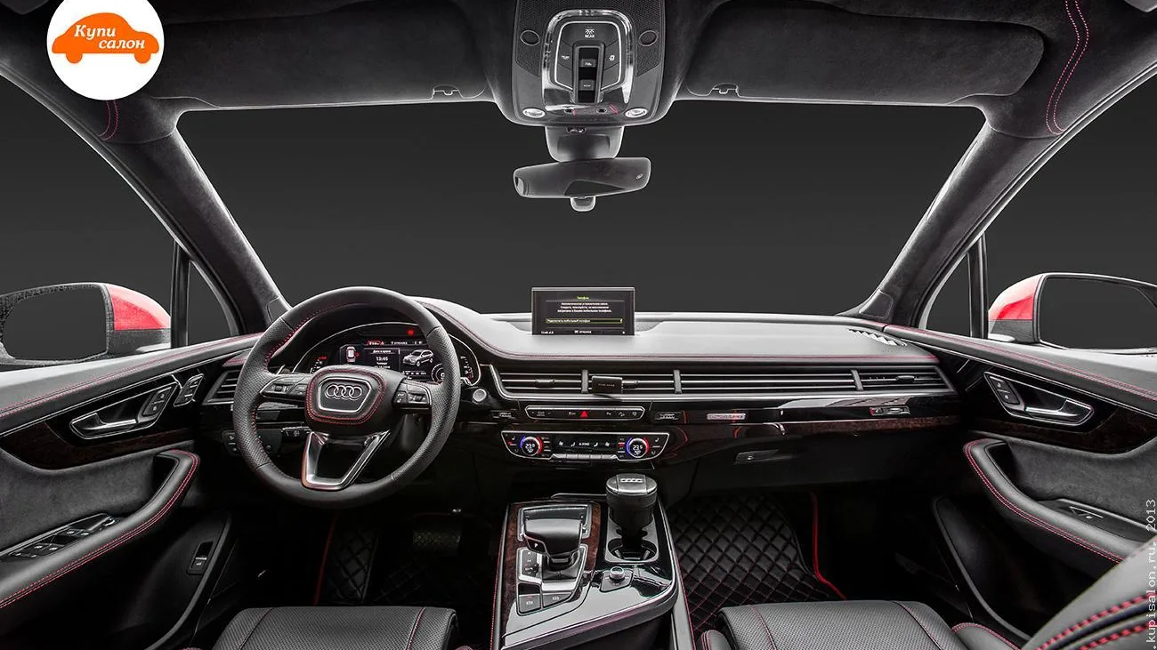Полная перетяжка салона Audi Q7 в черную кожу с красной строчкой и ромбовидной перфорацией.