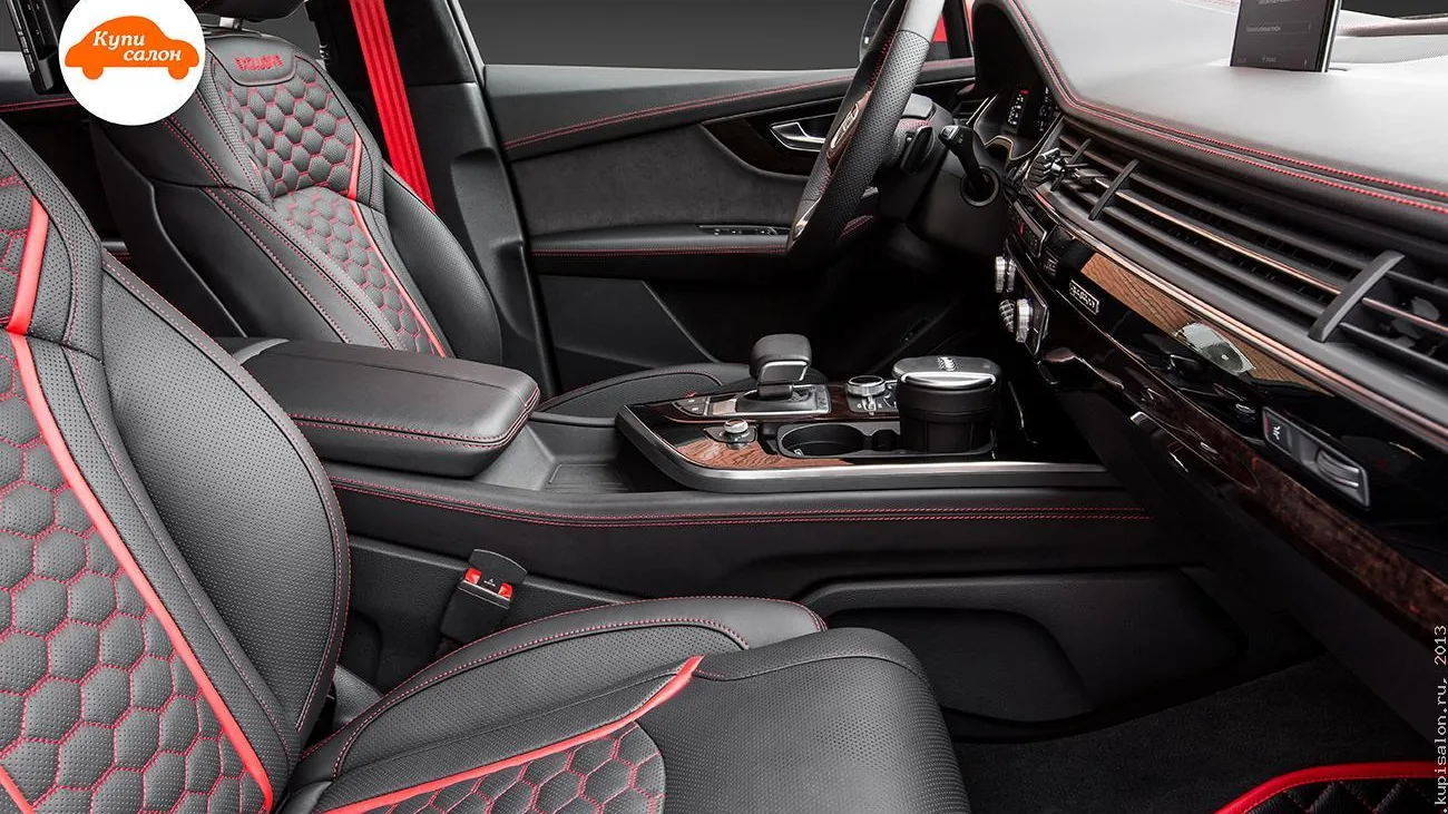 Перетяжка салона Audi Q7 ABT черной кожей с красной строчкой, сотами и вышивкой ABT на подголовниках.