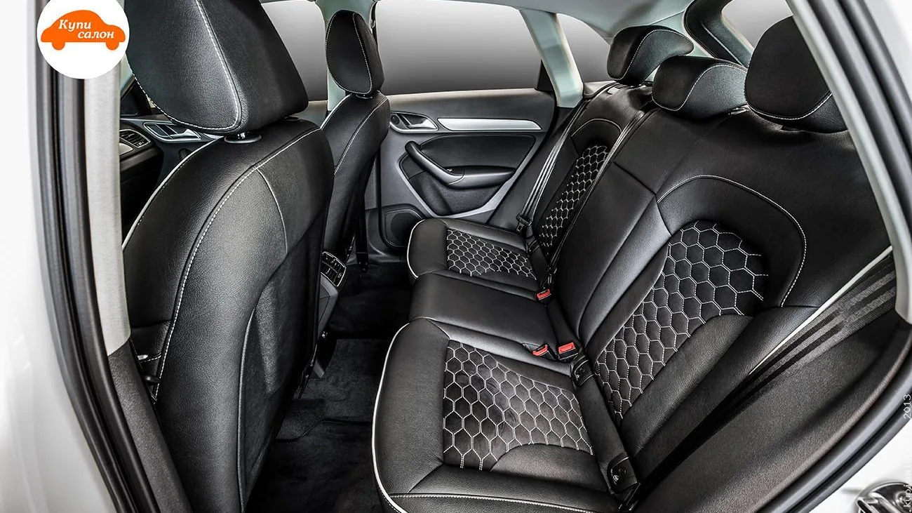 Перетяжка салона Audi Q3 черной экокожей с фигурной перфорацией сотами и белой строчкой