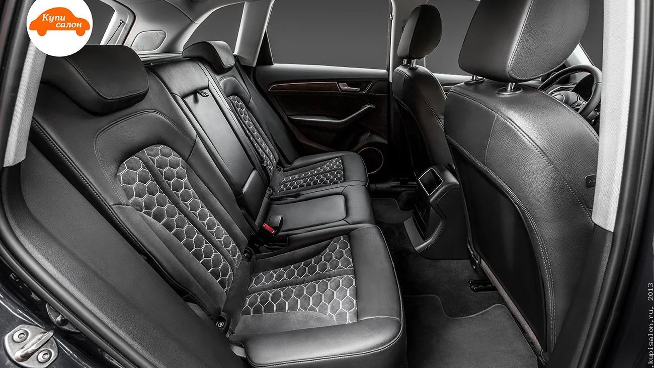 Перетяжка заднего ряда сидений Audi Q5 черной кожей с фигурной перфорацией сотами и белой строчкой.