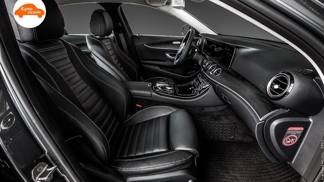 Перетяжка салона Mercedes-Benz E-класса черной кожей с белой строчкой