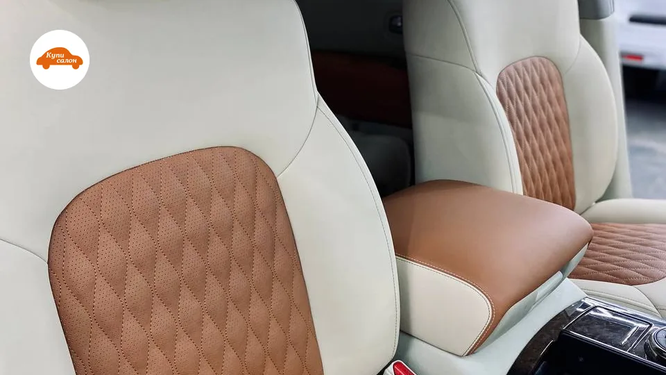 Перетяжка сидений Nissan Patrol — передние сиденья и центральный подлокотник в ракурсе три четверти