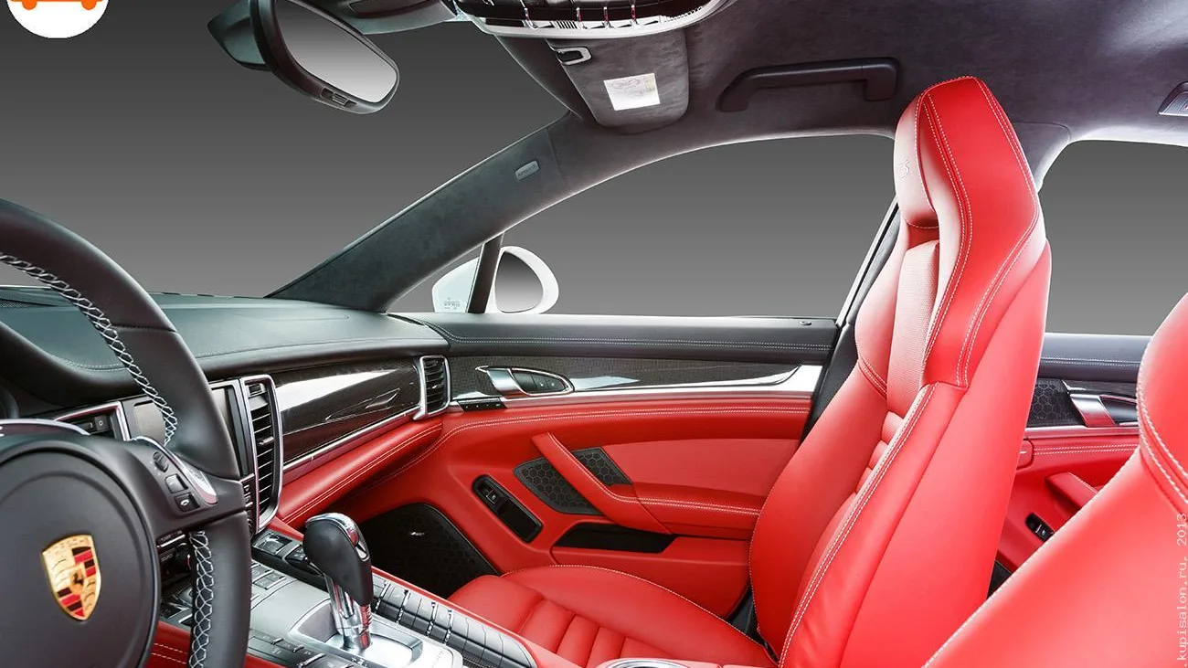 Перетяжка салона Porsche Panamera красной кожей с белой строчкой